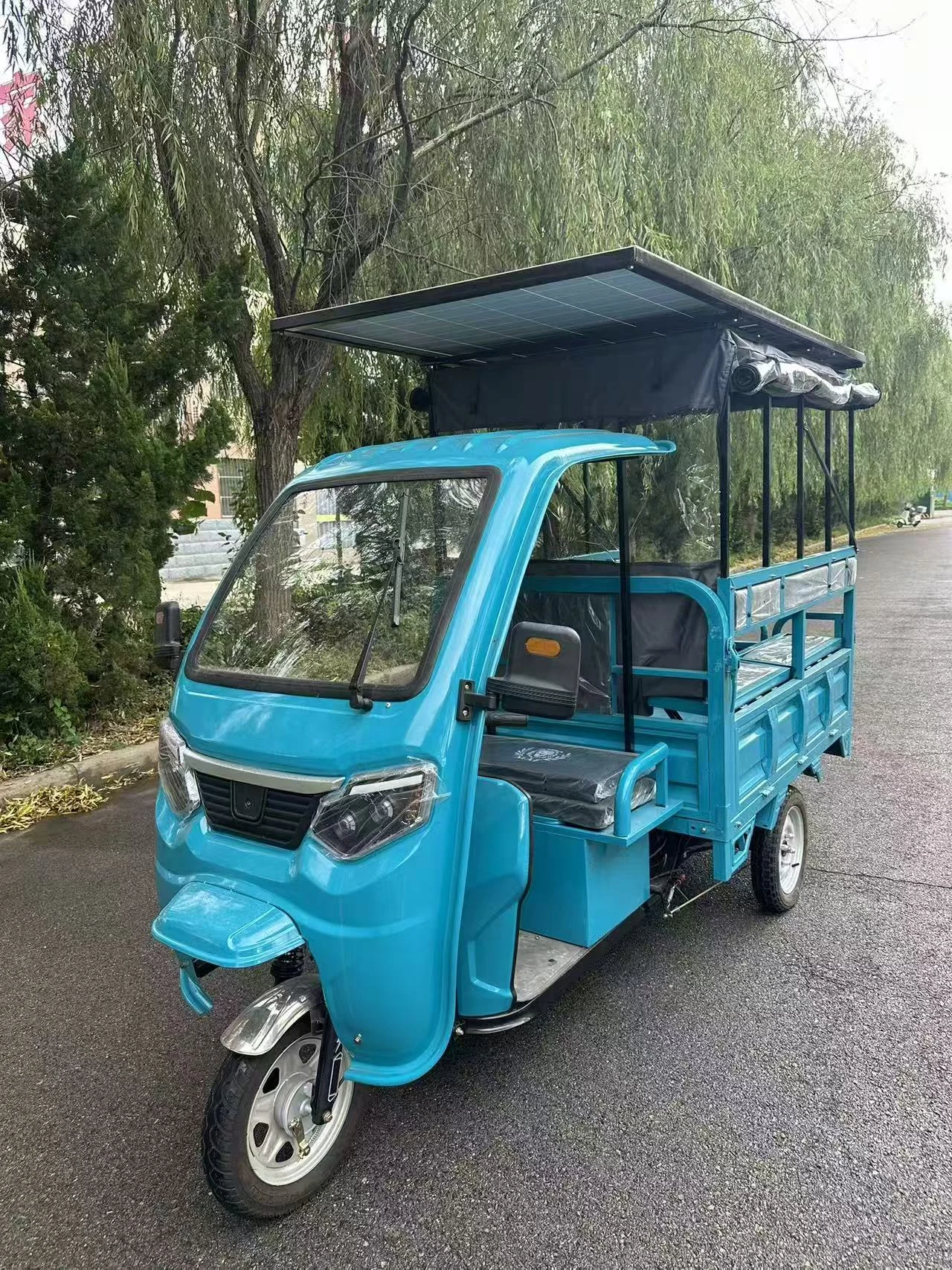 Blue solar roof tricycle, front three-quarter view